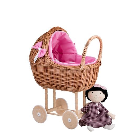 wicker doll stroller with pink trim, blanket, and pillow