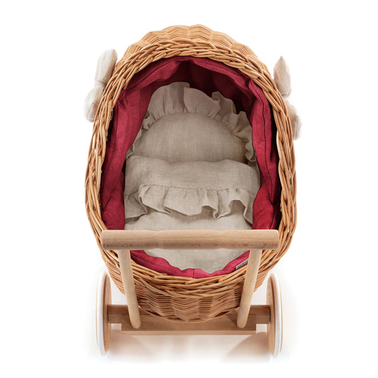 wicker doll stroller with red trim, blanket, and pillow, with handle