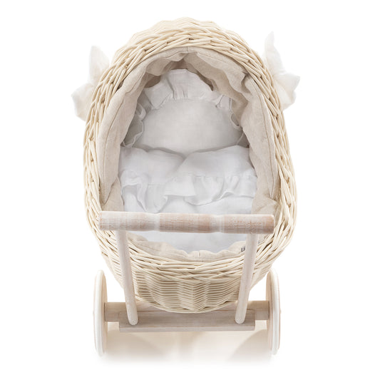 wicker doll stroller with beige linen trim, handle, blanket, and pillow