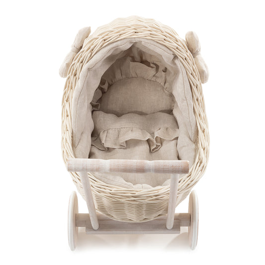 wicker doll stroller with cream trim, blanket, and pillow