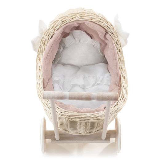 wicker doll stroller with pink trim, handle, pillow, and blanket