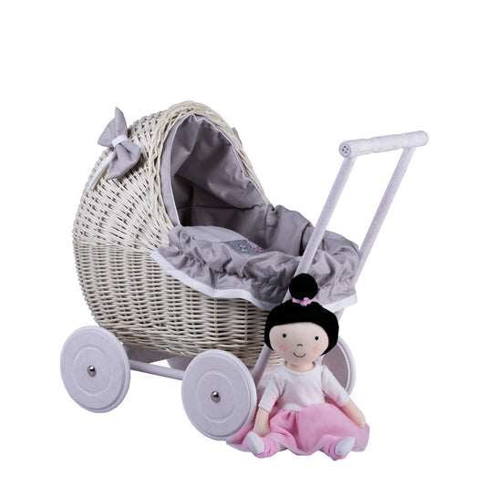 wicker doll stroller with gray trim, blanket, and pillow
