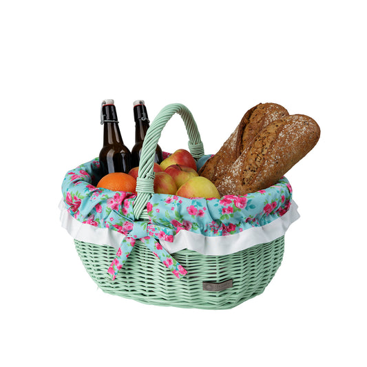 shopping basket with a wicker handle and green trim