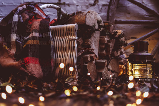 Fano wicker firewood basket with handle on wooden runners TheWickerStories