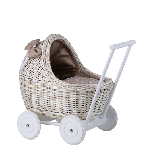 wicker doll stroller with beige trim, blanket, and pillow
