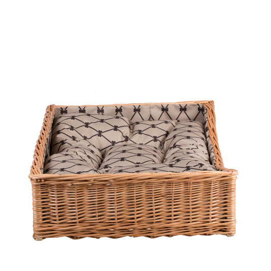 Eris wicker basket-bed for dogs and cats with beige trim, cushion and lowered entry TheWickerStories