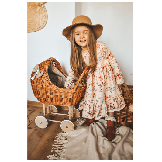 Lili wicker doll stroller with beige trim, blanket, and pillow