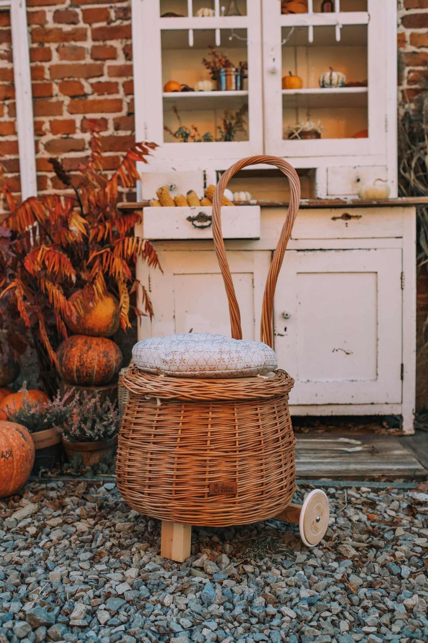 Salix wicker storage pouf with beige trim, cushion and caster wheels TheWickerStories