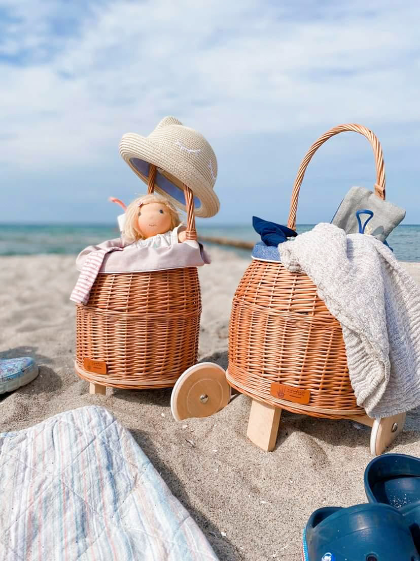 Luke wicker baby stroller with blue trim, handle, and wooden wheels TheWickerStories